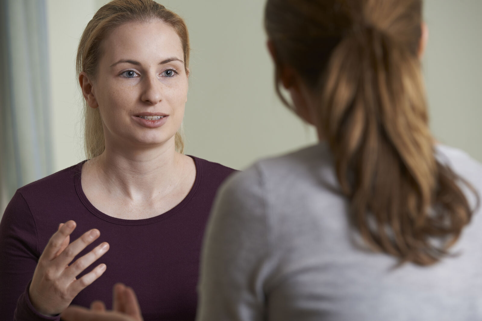 Two women talking animatedly